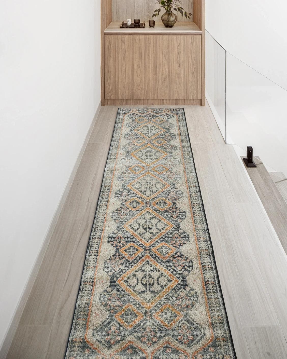 Julian Navy Runners carpet in beige, blue and multicolour, shown in a lifestyle front view