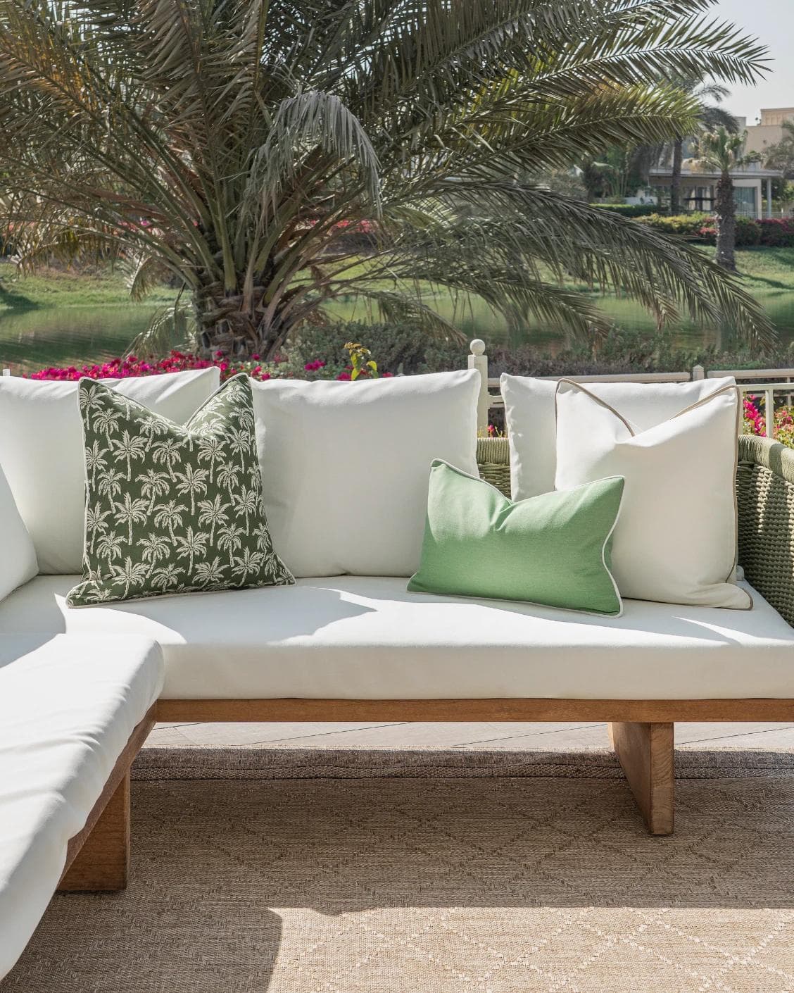 Keyla Bundle cushion in green and ivory, shown in a lifestyle front view as image 4