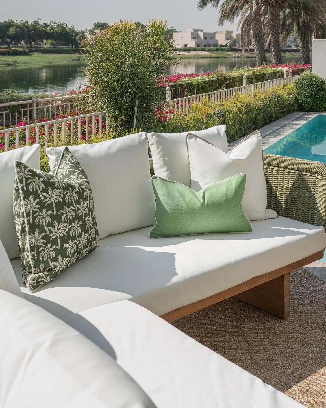 Keyla Bundle cushion in green and ivory, shown in a lifestyle left view as image 2