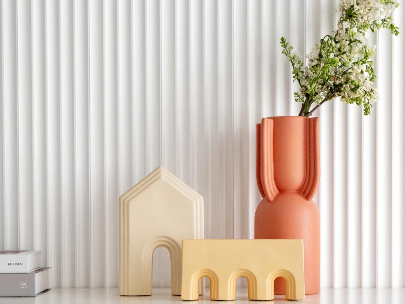 Klara Arneson vases in beige and orange, shown in a lifestyle front view as image 1