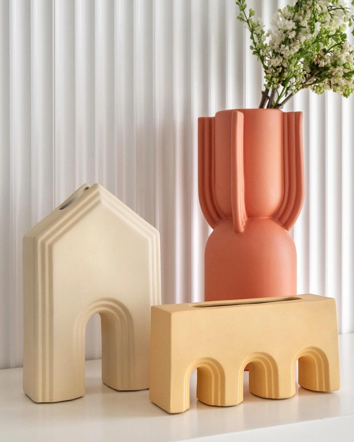 Klara Arneson vases in beige and orange, shown in a lifestyle front view as image 2