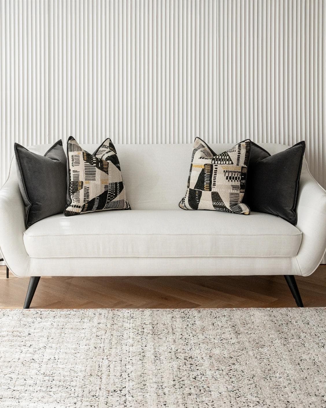 Krishna Bundle cushion in black, grey and beige, shown in a lifestyle front view as image 4