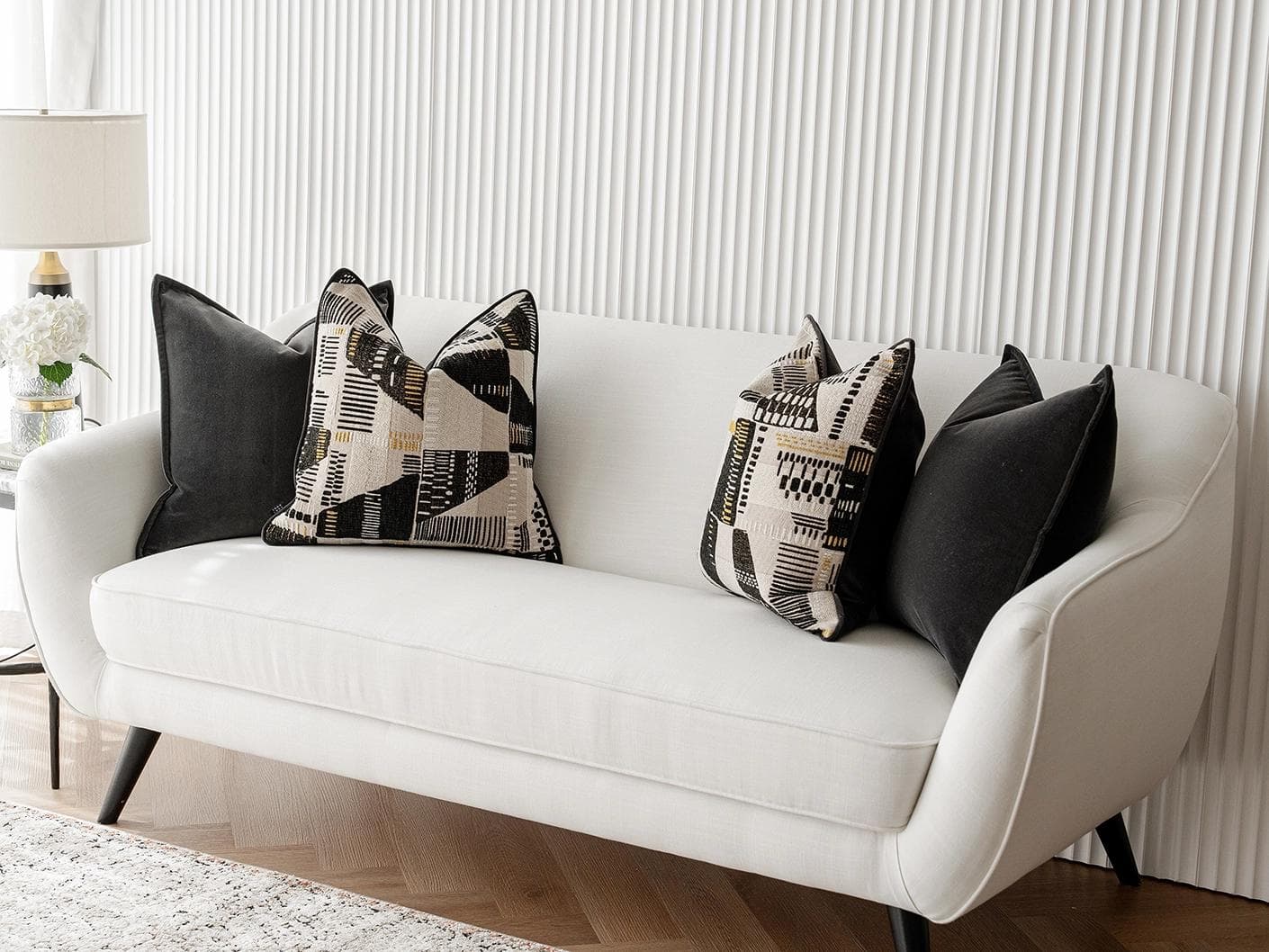 Krishna Bundle cushion in black, grey and beige, shown in a lifestyle right view as image 2