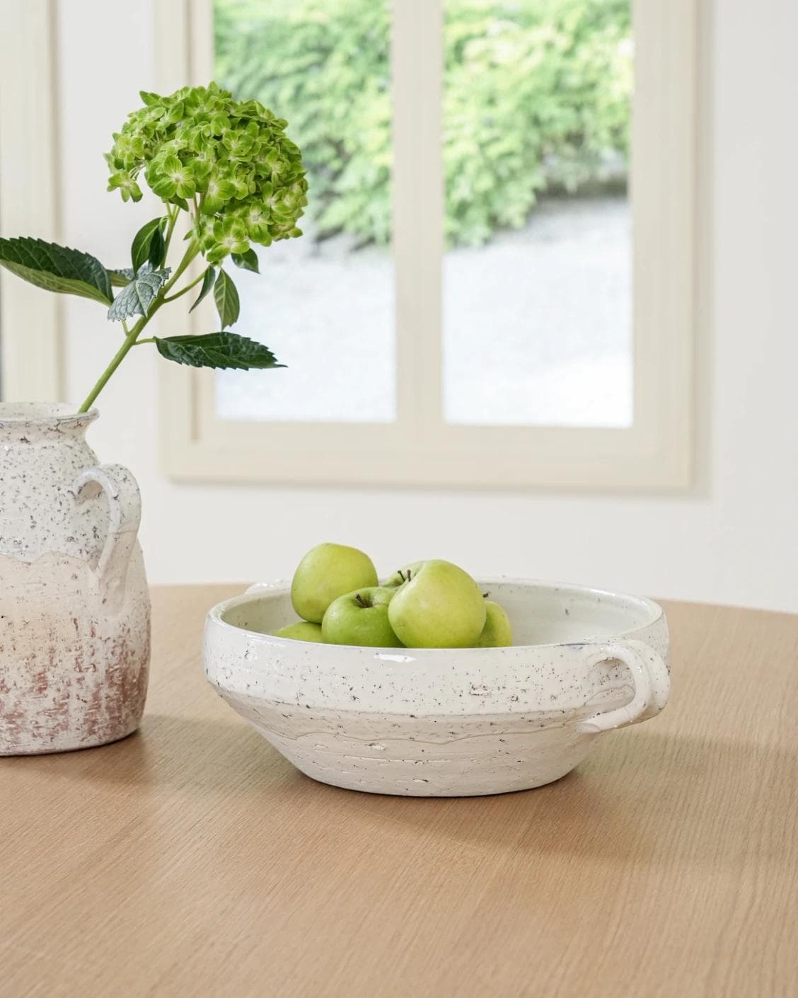 Kyan Terra bowls in soft stone and white, shown in a lifestyle front view as image 2