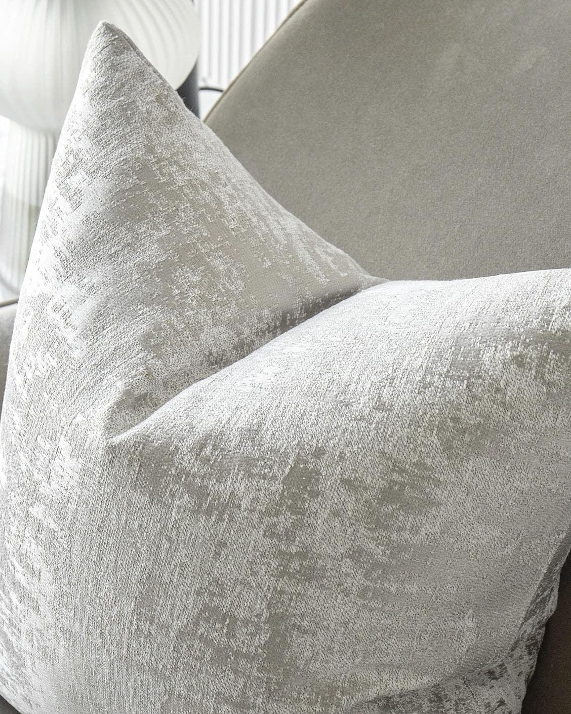Kylie Hodler cushion in silver and grey, shown in a lifestyle top view as image 5