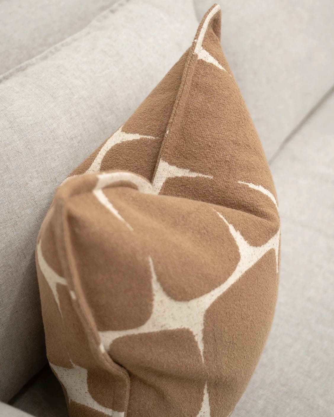 Kyomi Braun cushion in brown, shown in a lifestyle top view as image 5