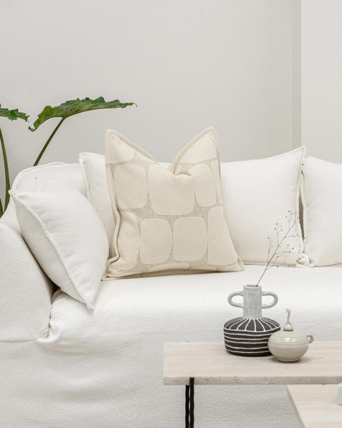 Kyomi Klimt cushion in ivory and beige, shown in a lifestyle front view as image 4