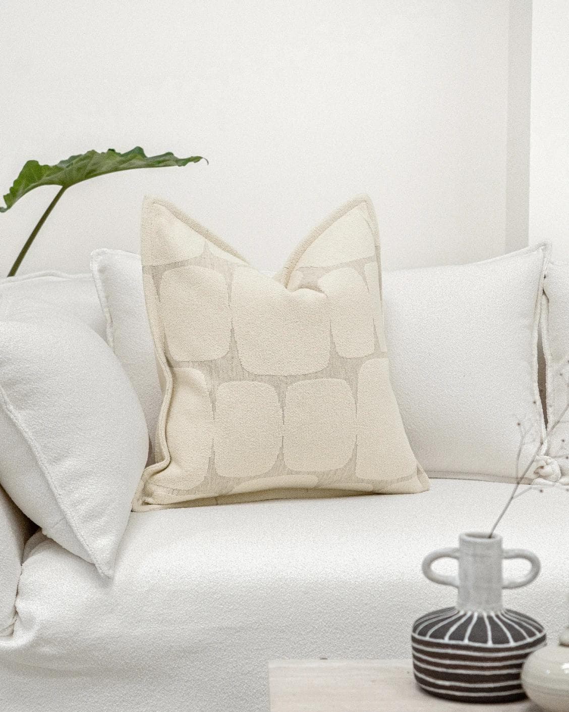 Kyomi Klimt cushion in ivory and beige, shown in a lifestyle front view as image 2
