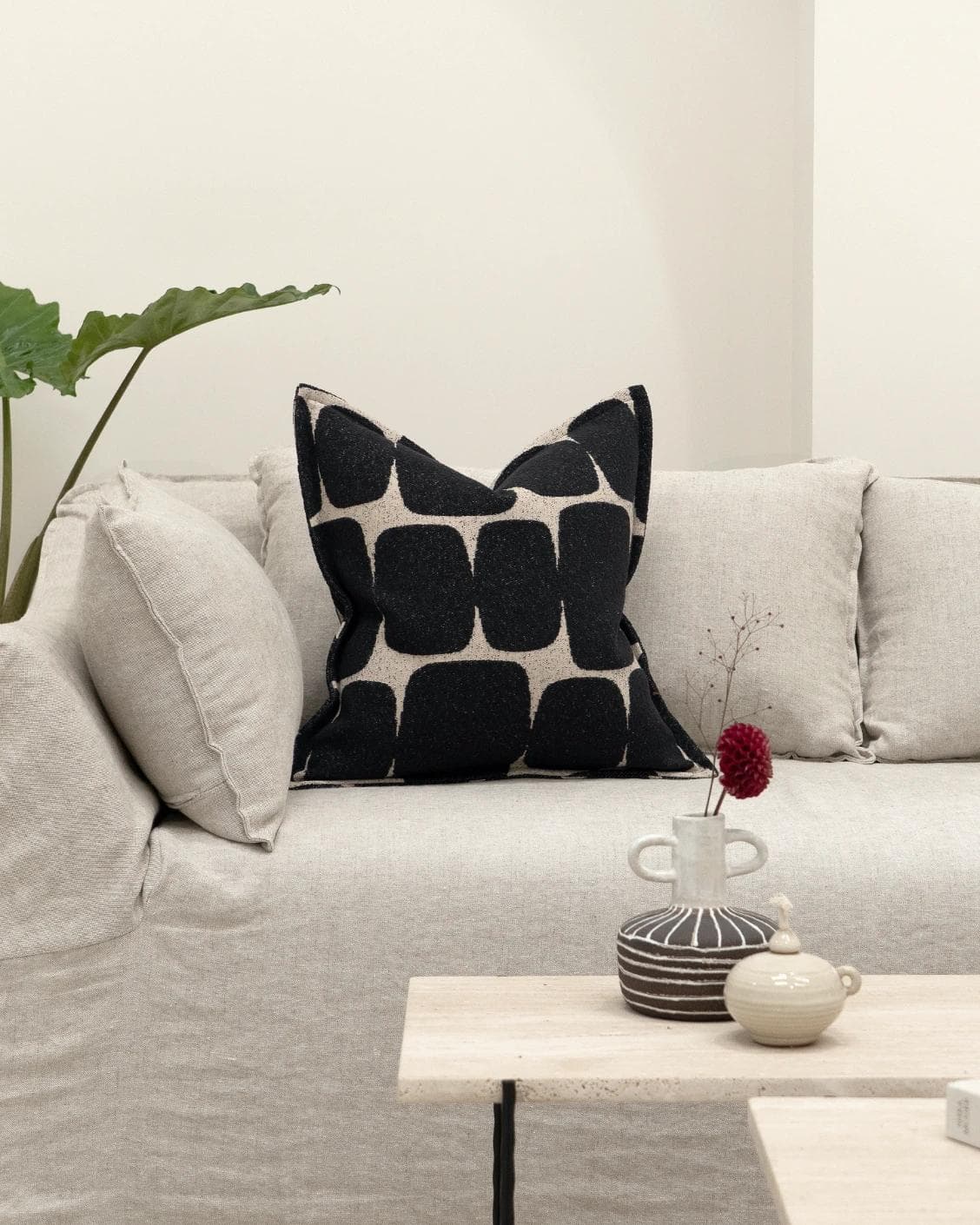 Kyomi Steele cushion in charcoal, shown in a lifestyle front view as image 4