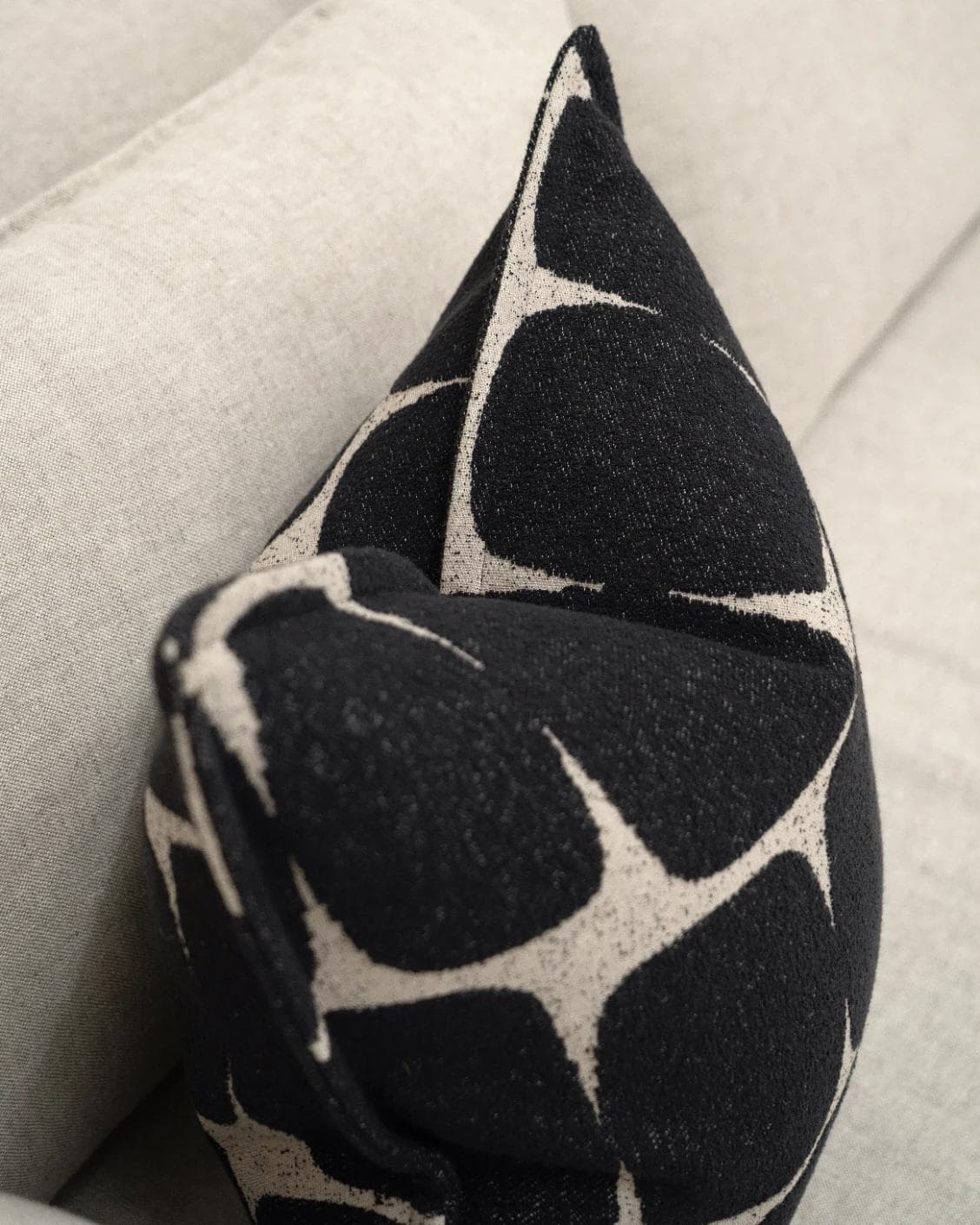 Kyomi Steele cushion in charcoal, shown in a lifestyle top view as image 5