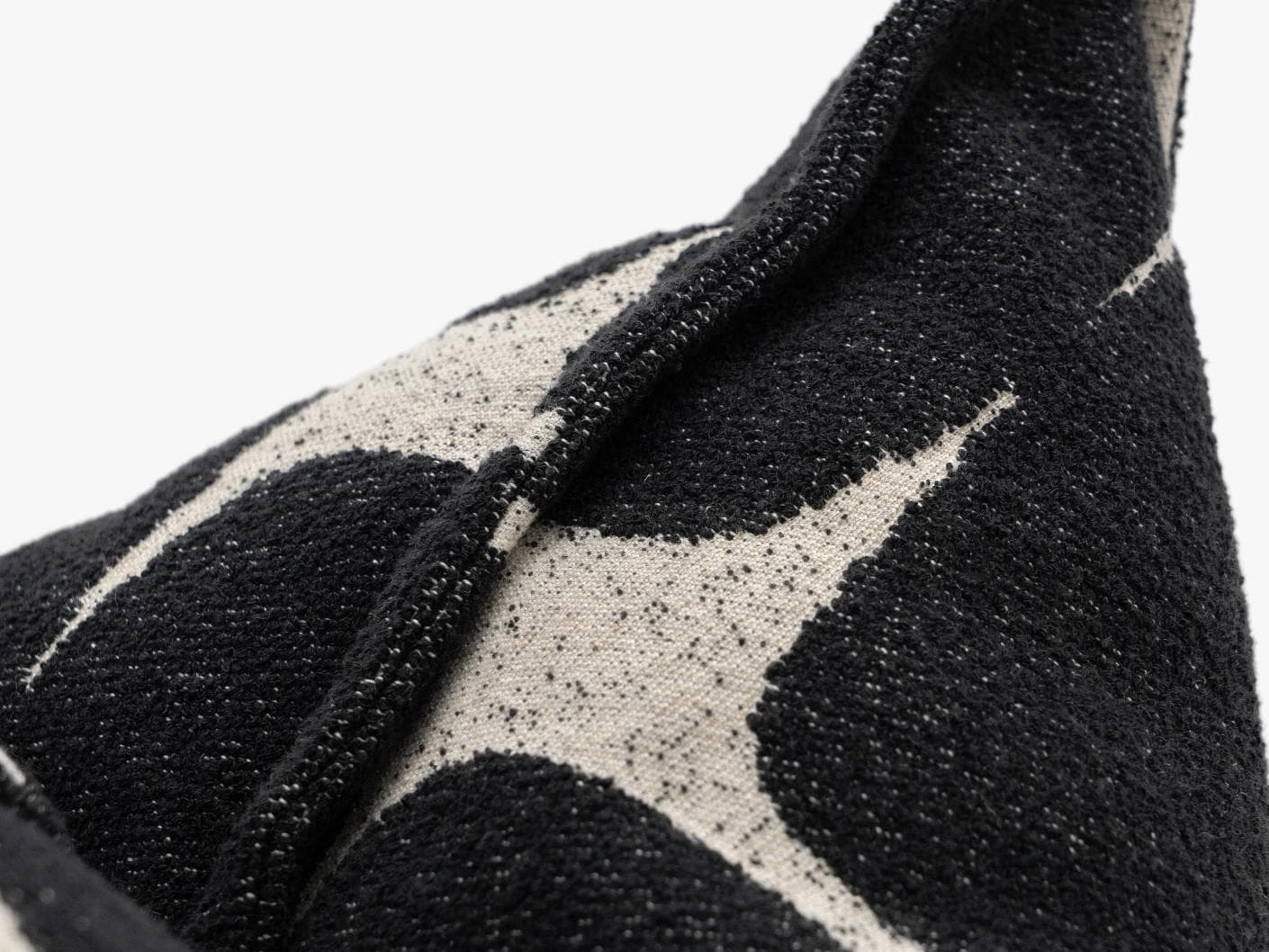 Kyomi Steele cushion in charcoal, shown in a product close-up as image 7