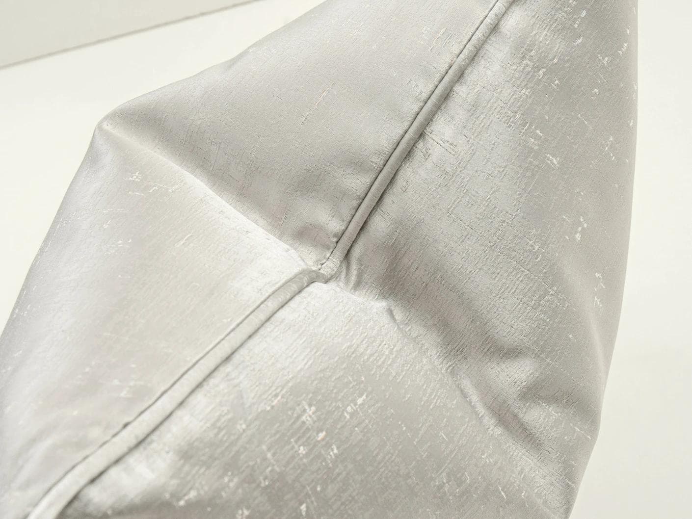Lainie Laurent cushion in silver, shown in a lifestyle top view as image 6