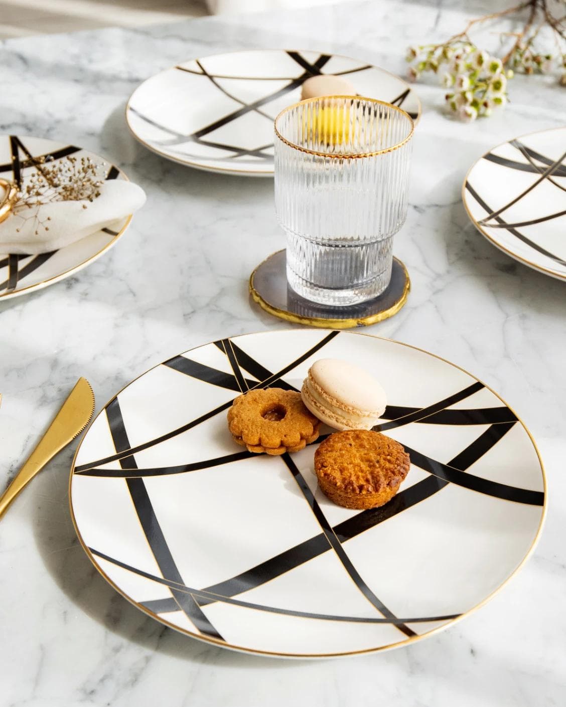 Leanna Viktoria plates in white, black and gold, shown in a lifestyle front view as image 4