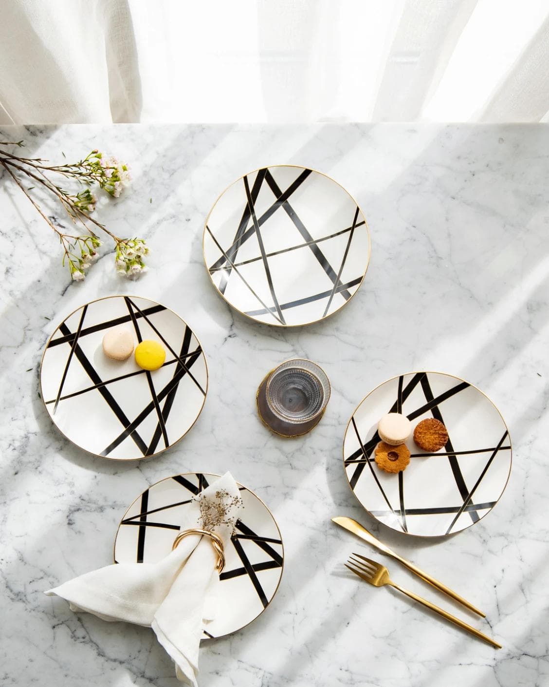 Leanna Viktoria plates in white, black and gold, shown in a lifestyle top view as image 5