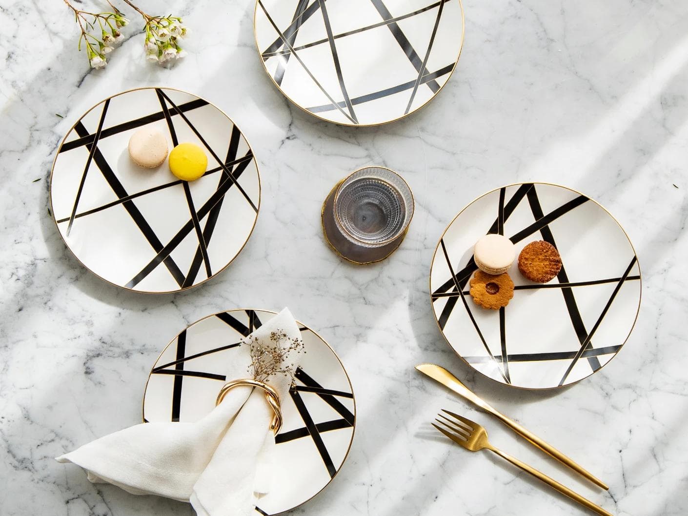 Leanna Viktoria plates in white, black and gold, shown in a lifestyle top view as image 5