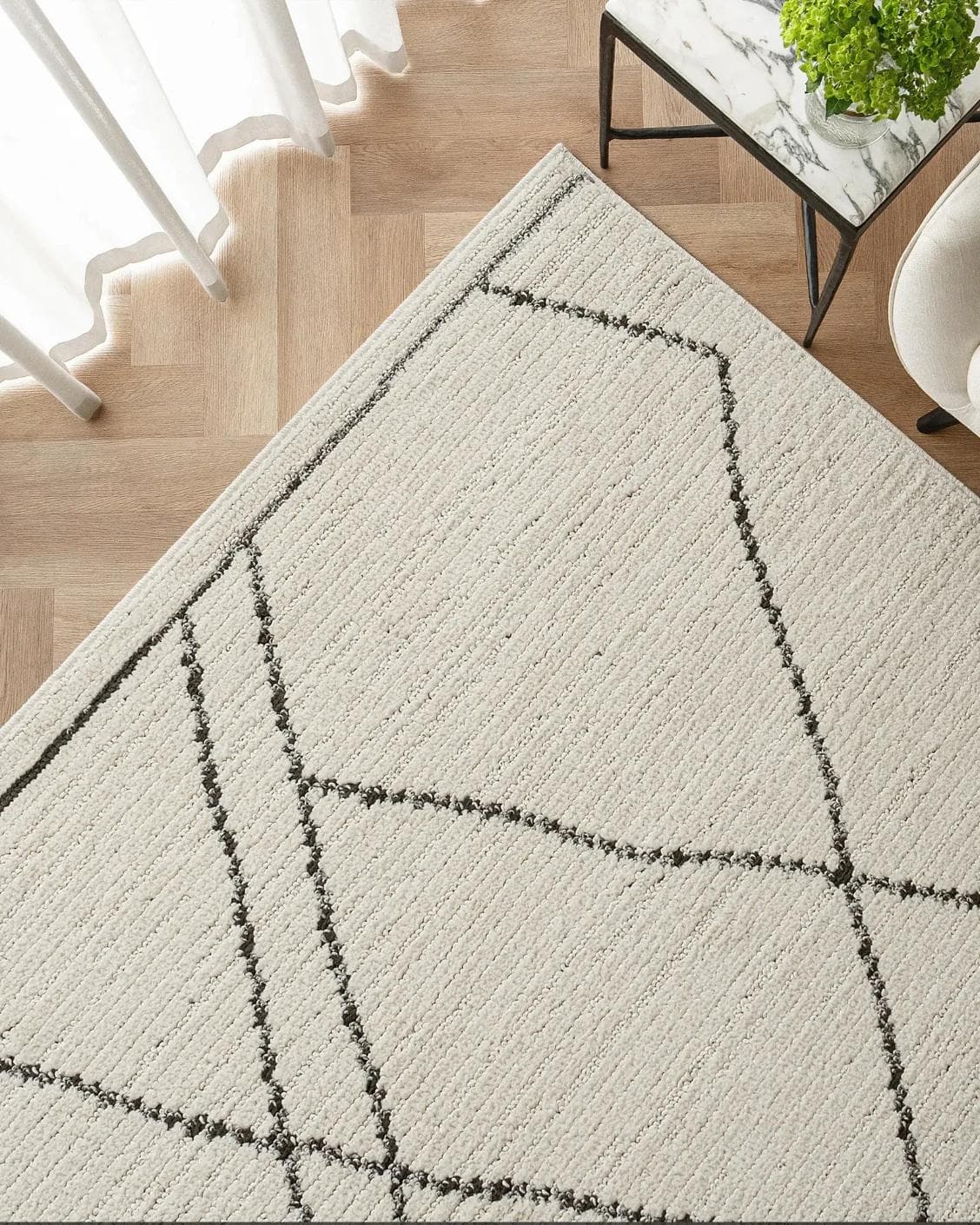 Leila Bianca carpet in beige and charcoal, shown in a lifestyle top view as image 2