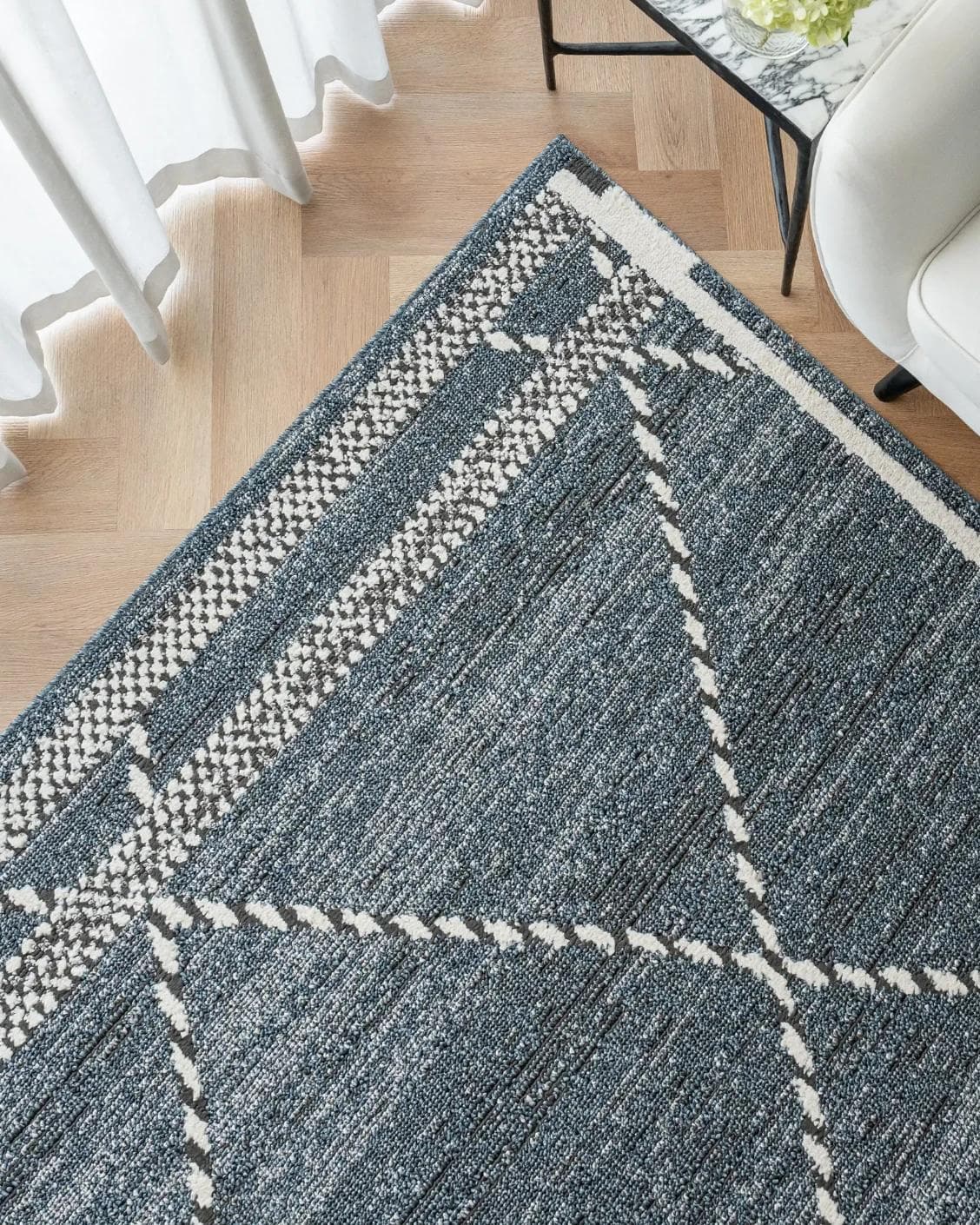 Leila Sky carpet in blue, shown in a lifestyle top view as image 2