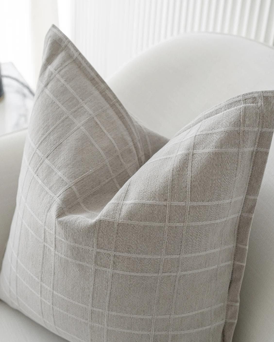 Lenora Laurent cushion in grey, shown in a lifestyle top view as image 6