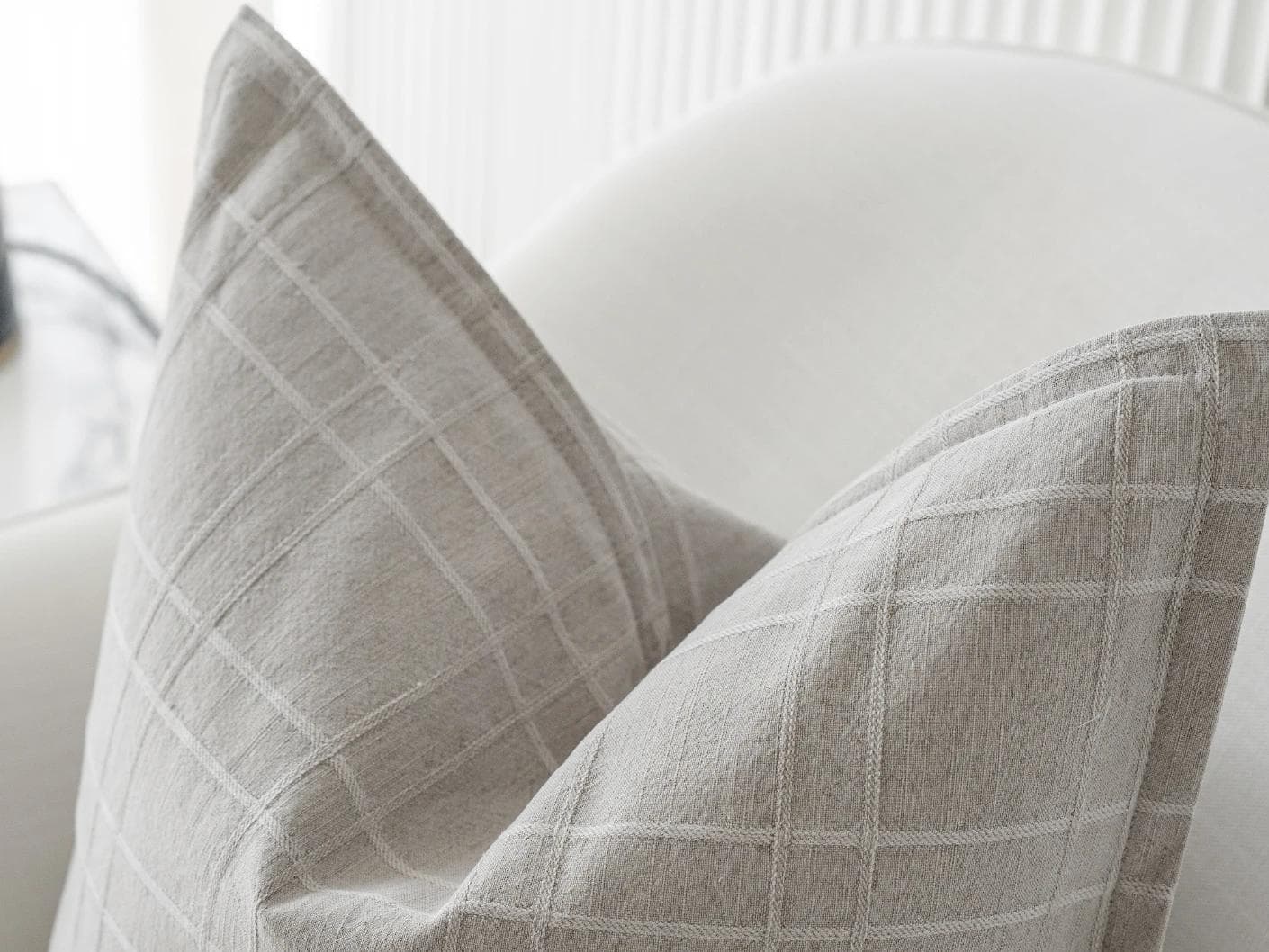 Lenora Laurent cushion in grey, shown in a lifestyle top view as image 6