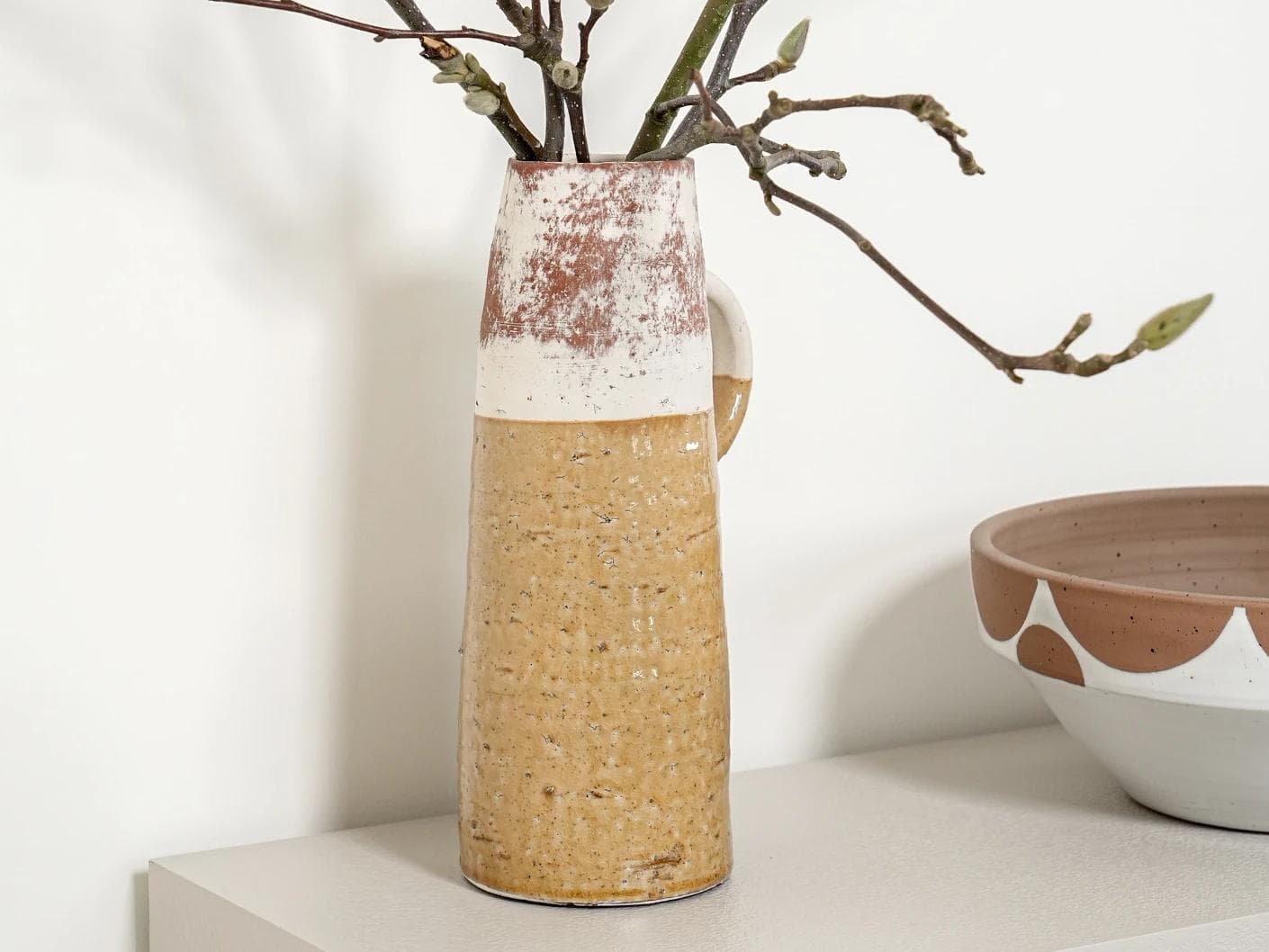 Leva Terra vases in white and beige, shown in a lifestyle front view as image 2