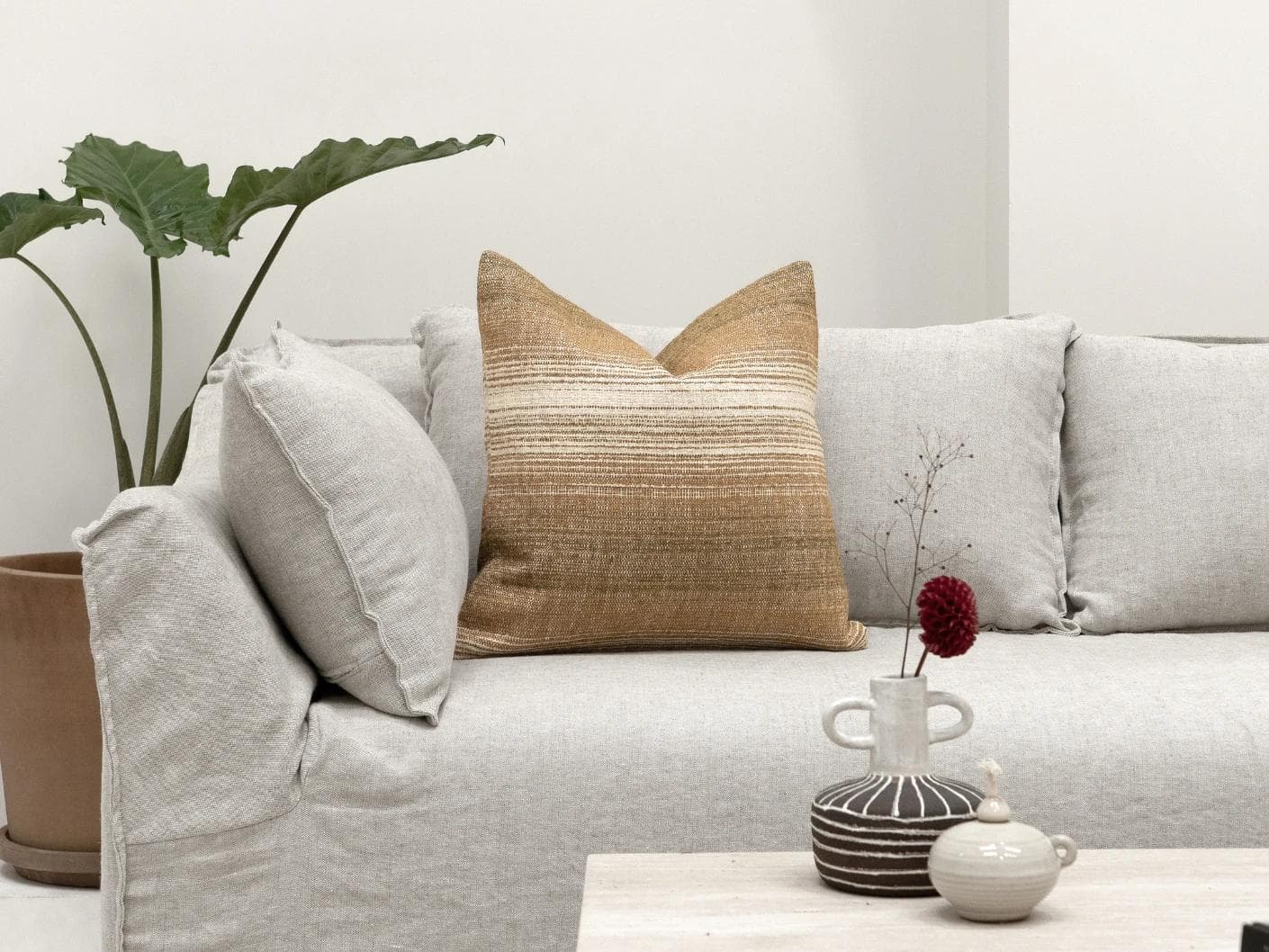 Lia Ember cushion in brown, shown in a lifestyle front view as image 4