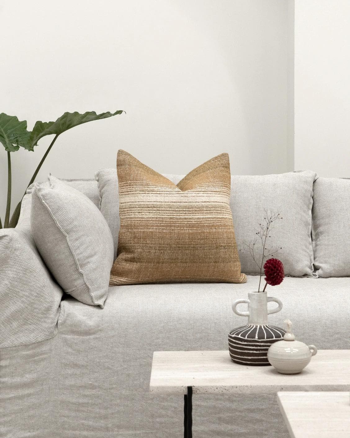 Lia Ember cushion in brown, shown in a lifestyle front view as image 4