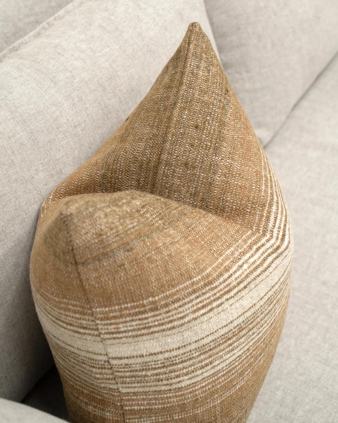 Lia Ember cushion in brown, shown in a lifestyle top view as image 5