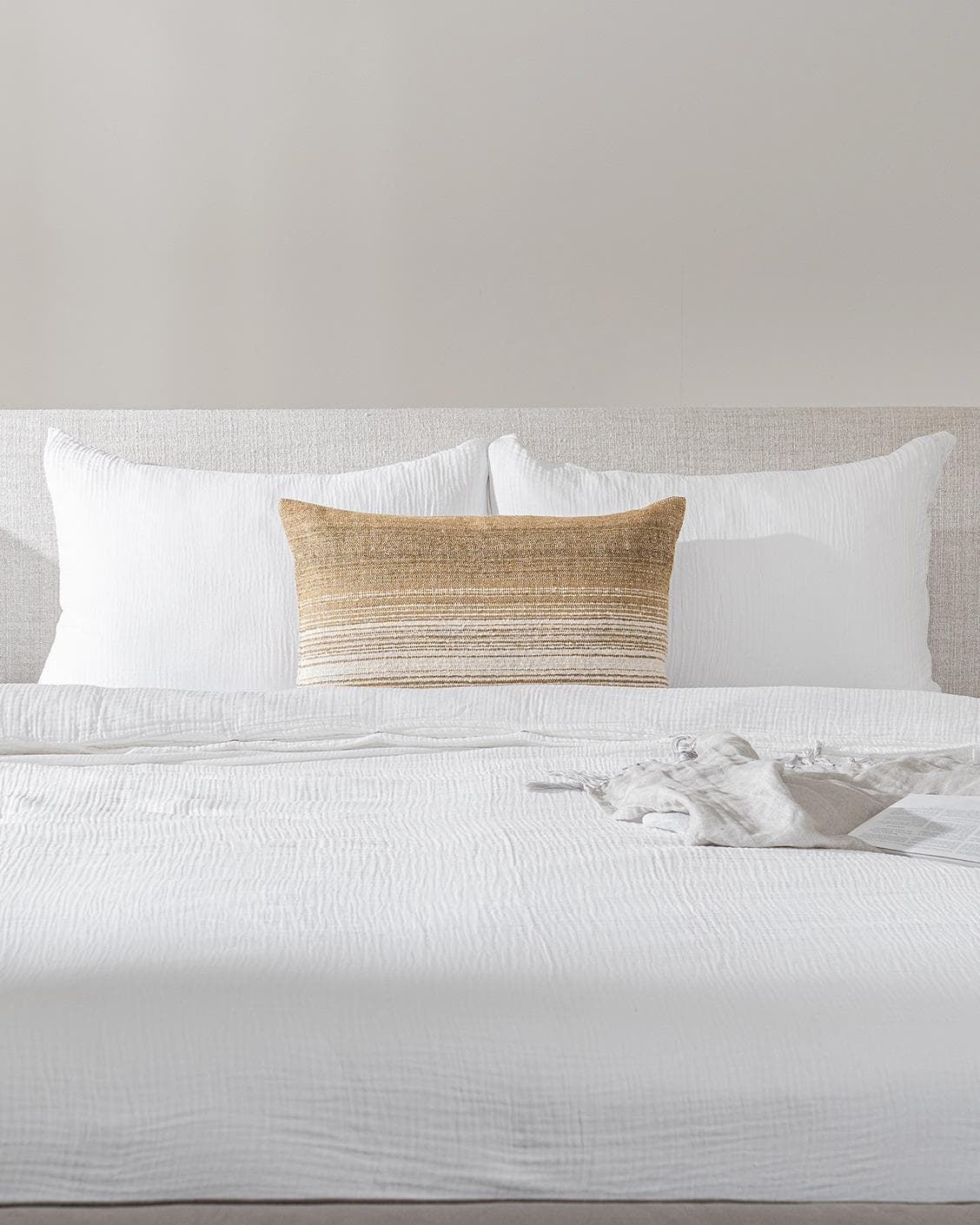 Lia Ember III cushion in cream, shown in a lifestyle front view as image 2