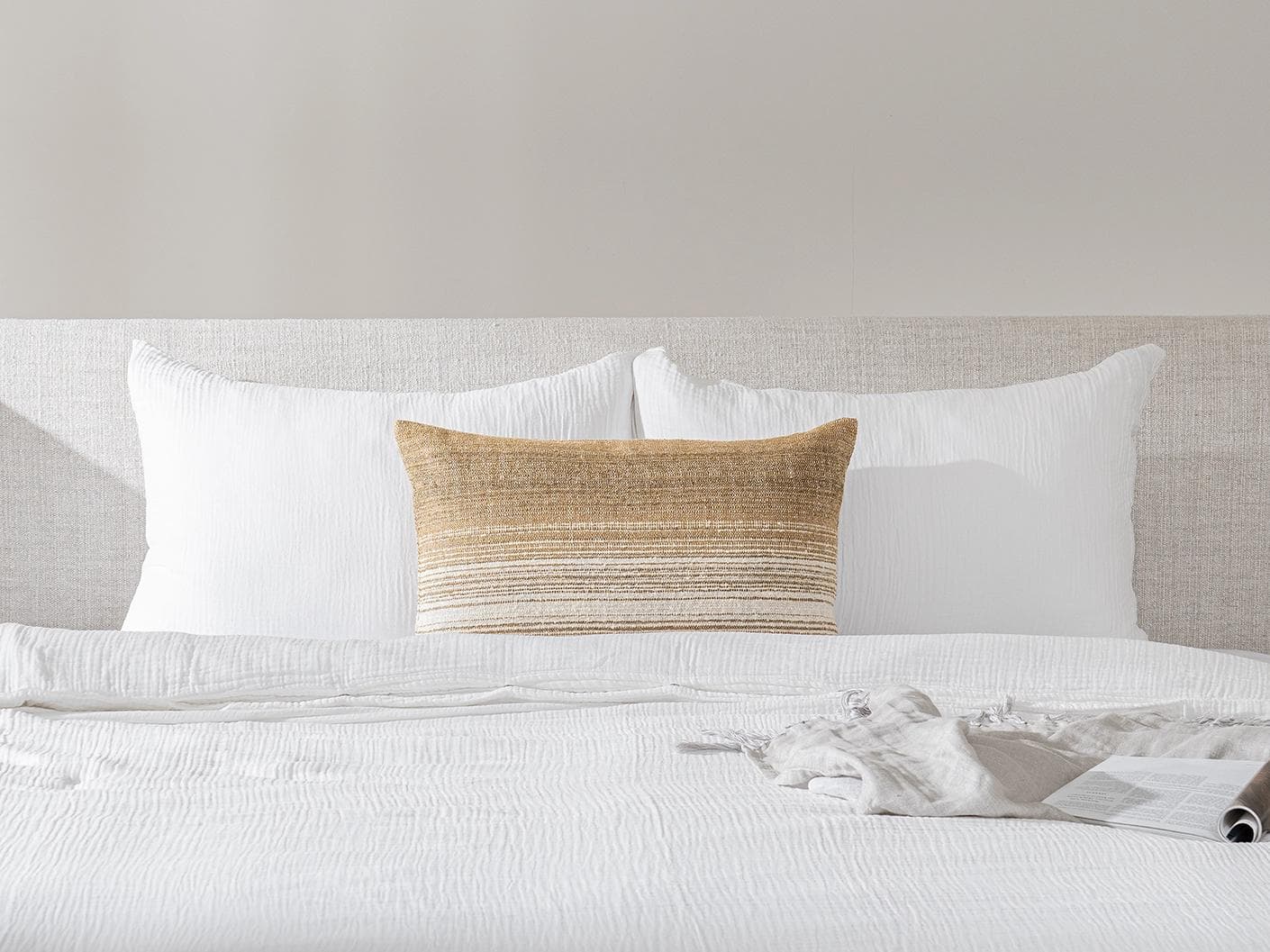 Lia Ember III cushion in cream, shown in a lifestyle front view as image 2