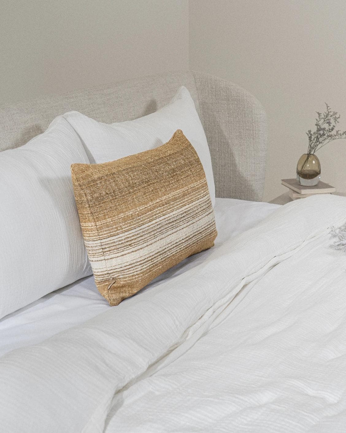 Lia Ember III cushion in cream, shown in a lifestyle left view as image 4