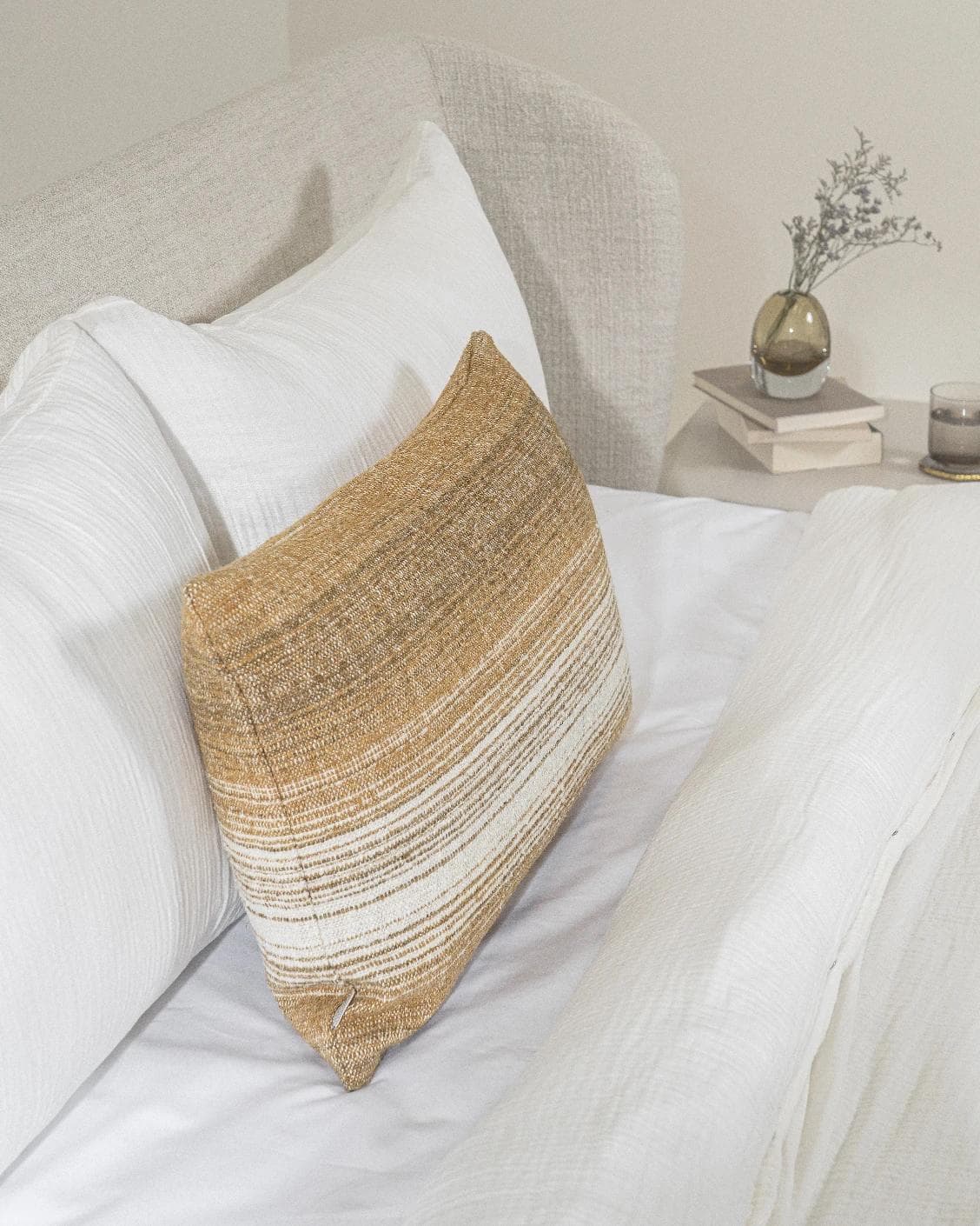 Lia Ember III cushion in cream, shown in a lifestyle left view as image 5