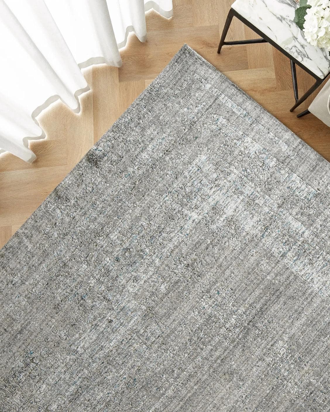 Liam Ashton carpet in grey, shown in a lifestyle top view as image 2