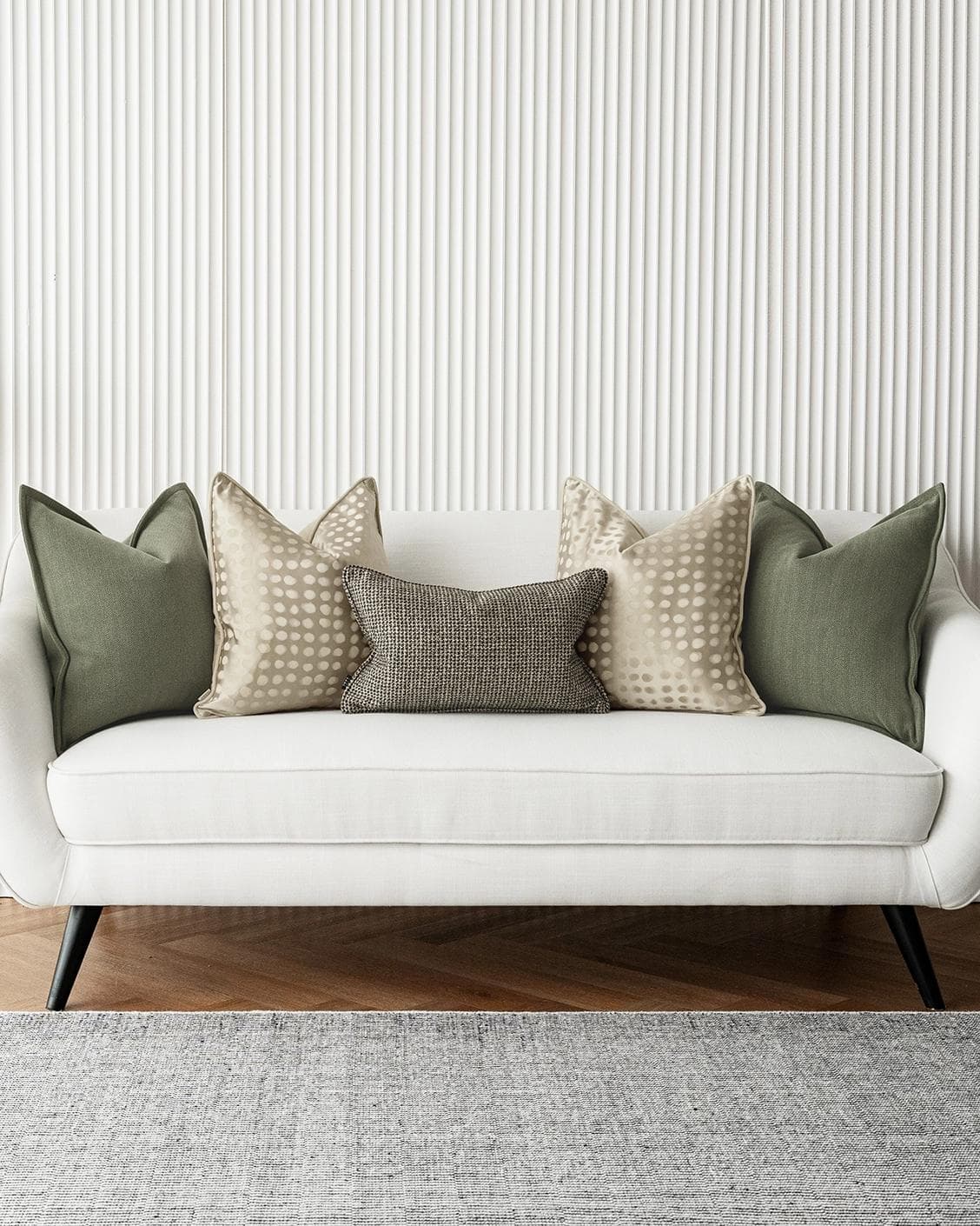 Lirika Bundle cushion in black, green, beige and gold, shown in a lifestyle front view as image 4