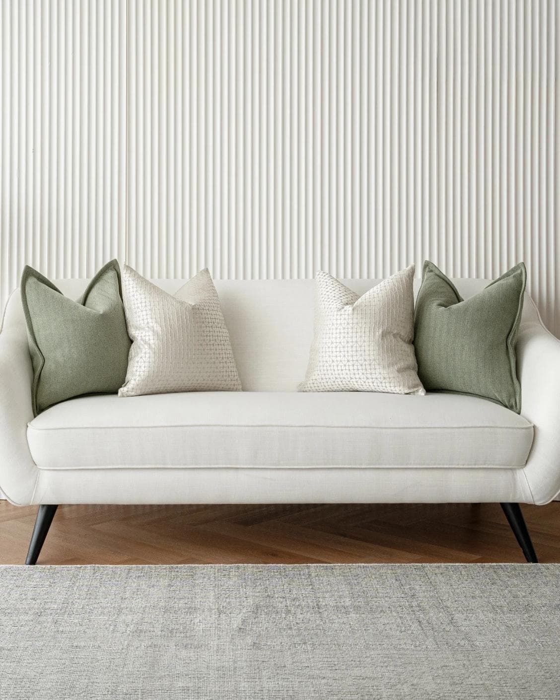 Lloyd Bundle cushion in silver, white and green, shown in a lifestyle front view as image 4