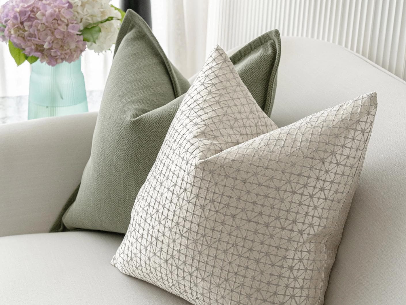 Lloyd Bundle cushion in silver, white and green, shown in a lifestyle top view as image 5