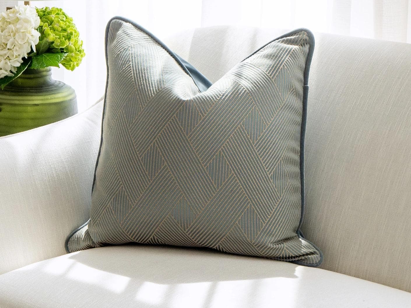 Lucas Matisse cushion in blue, shown in a lifestyle front view as image 2