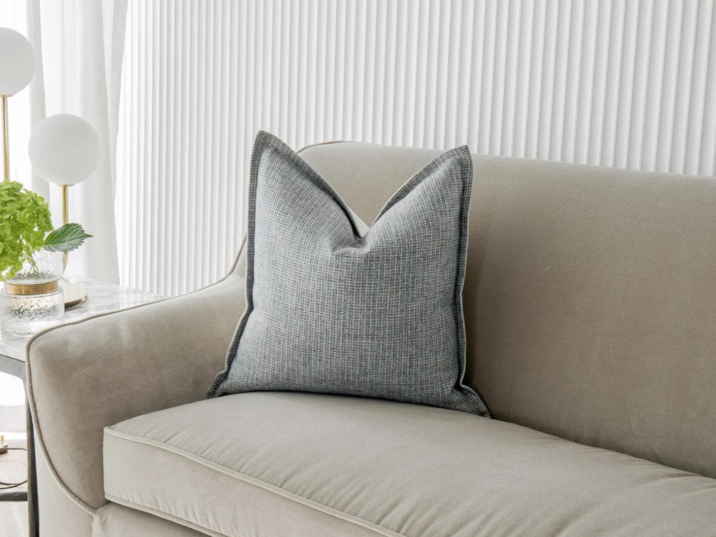 Luis Canova cushion in blue, shown in a lifestyle front view as image 2