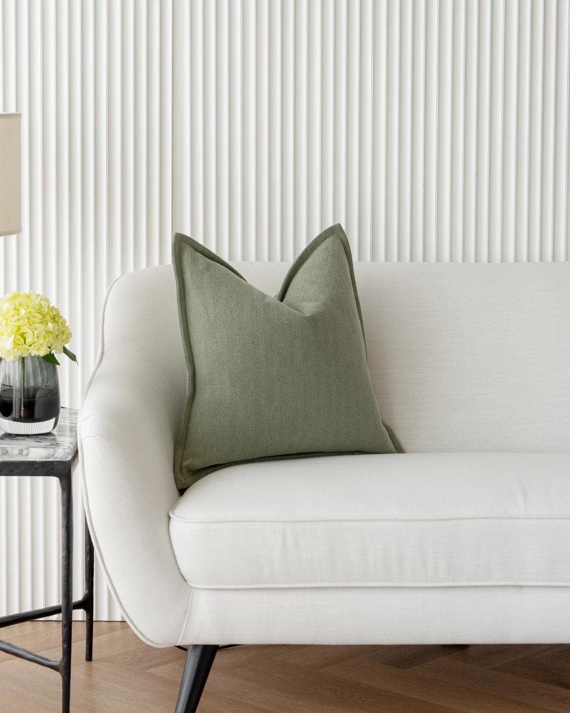 Lyndon Sage cushion in green, shown in a lifestyle front view as image 5