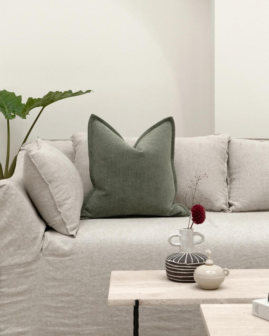 Macey Jade cushion in grey and green, shown in a lifestyle front view as image 4