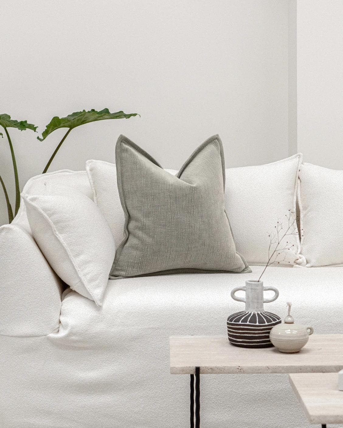 Macey Laurent cushion in grey, shown in a lifestyle front view as image 4