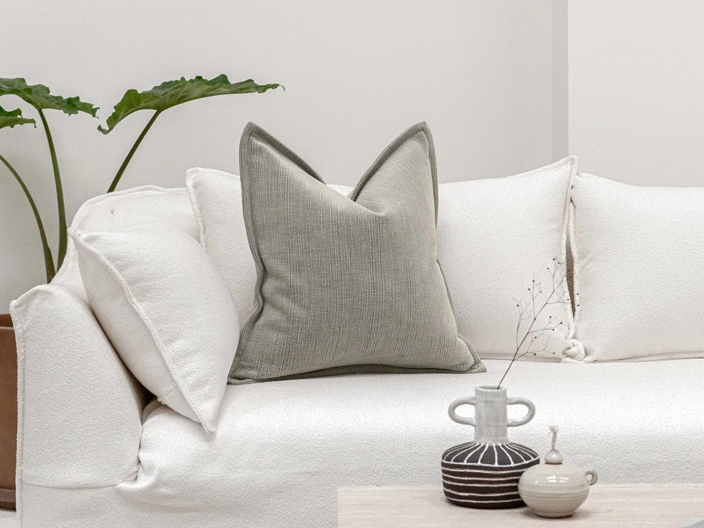 Macey Laurent cushion in grey, shown in a lifestyle front view as image 4