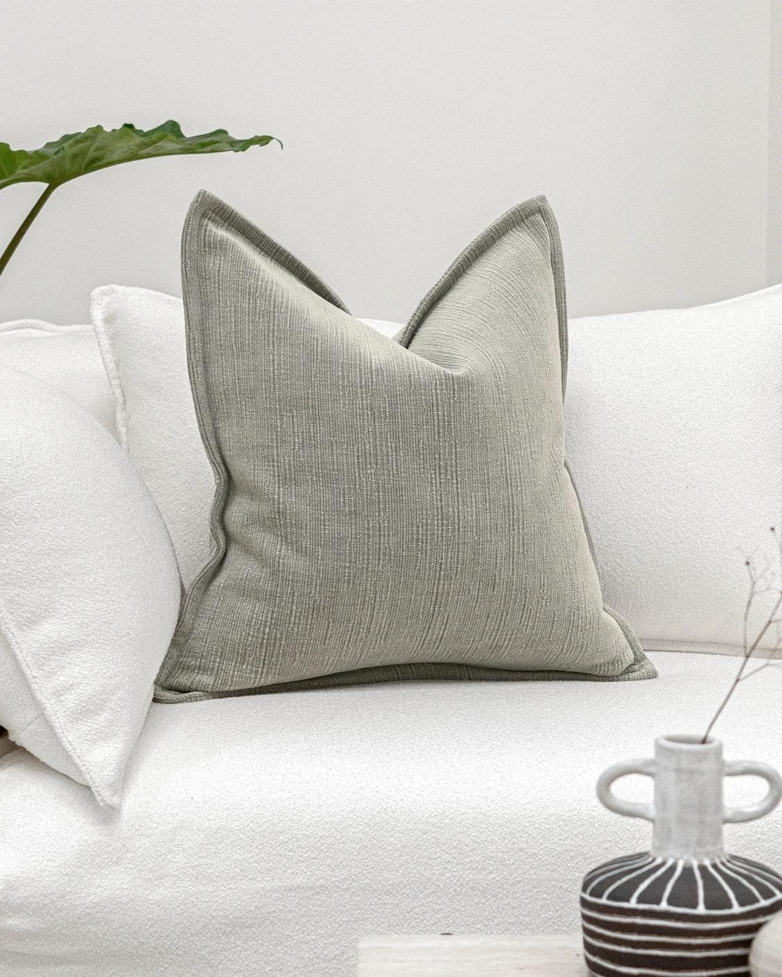 Macey Laurent cushion in grey, shown in a lifestyle front view as image 2