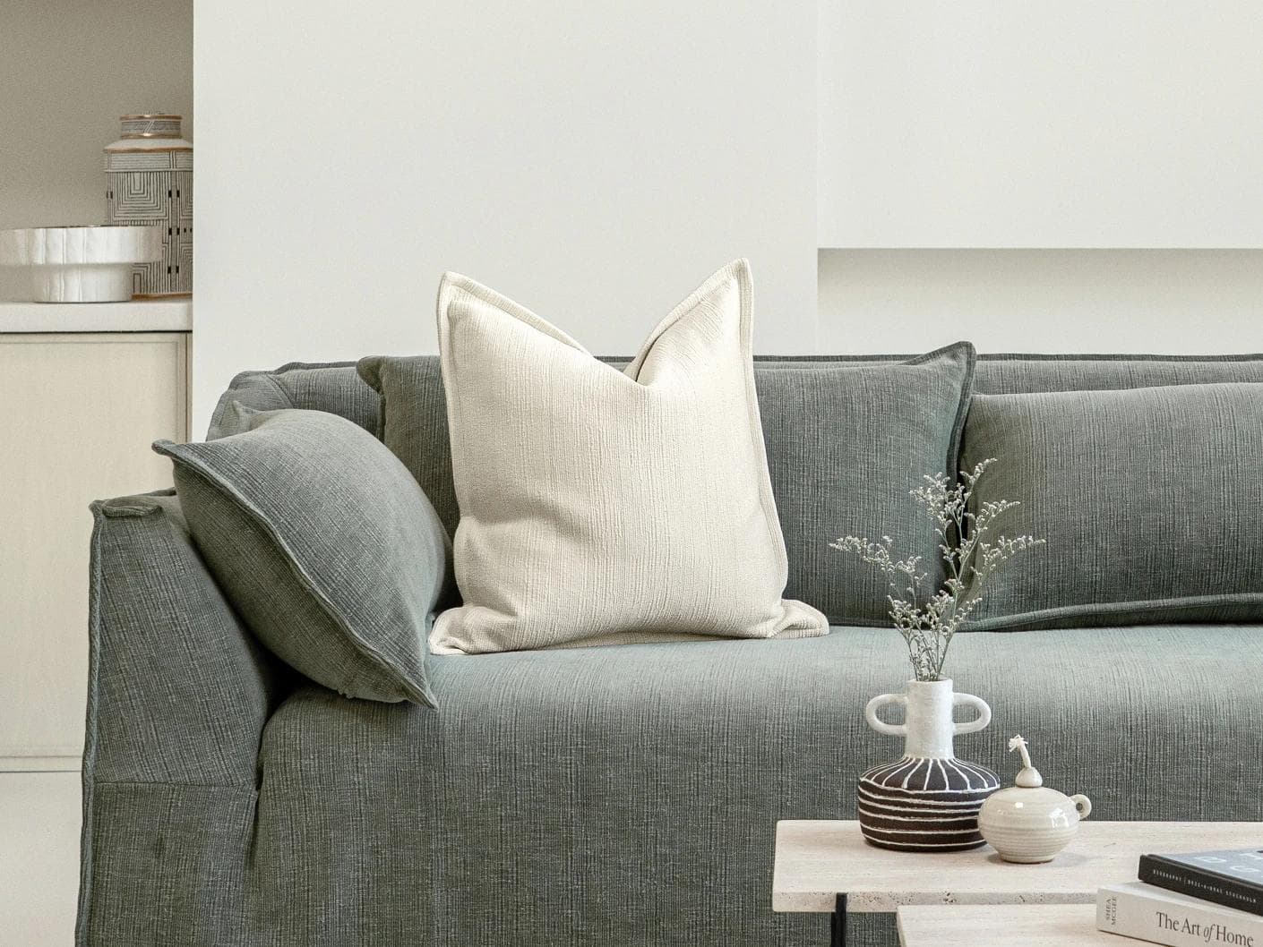 Macey Shale cushion in ivory, shown in a lifestyle front view as image 4