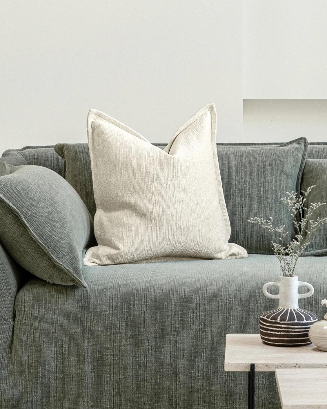 Macey Shale cushion in ivory, shown in a lifestyle front view as image 4