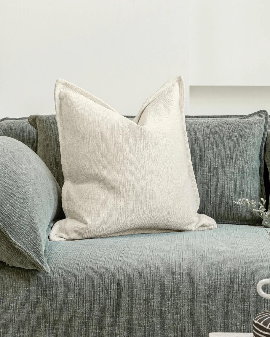 Macey Shale cushion in ivory, shown in a lifestyle front view as image 2