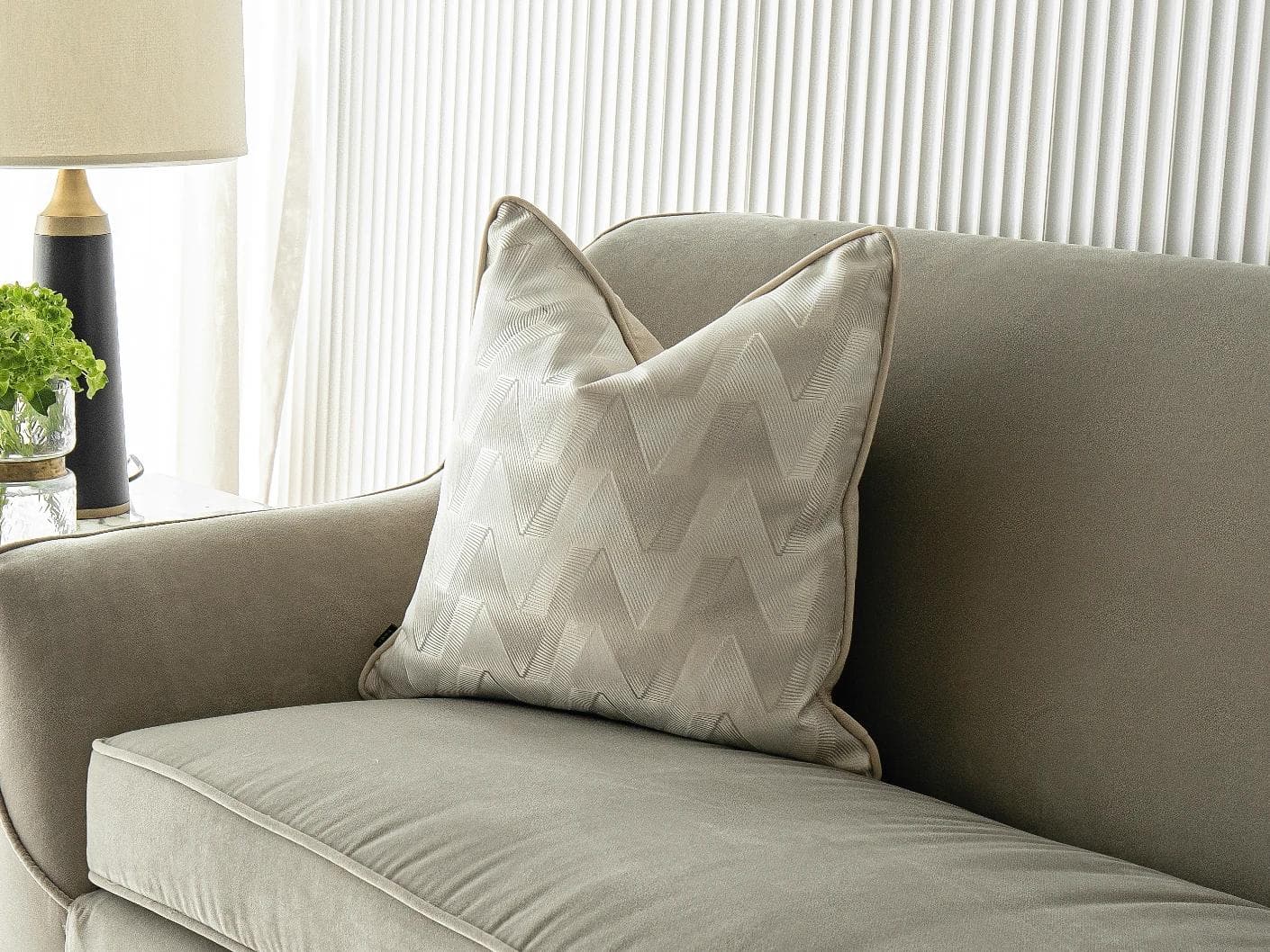Maisie River cushion in beige and silver, shown in a lifestyle front view as image 2