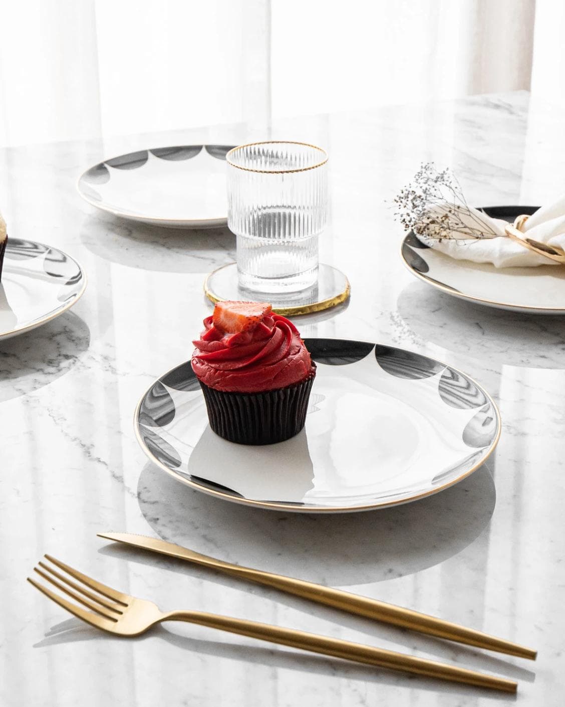 Malikka Viktoria plates in black and white, shown in a lifestyle left view as image 2