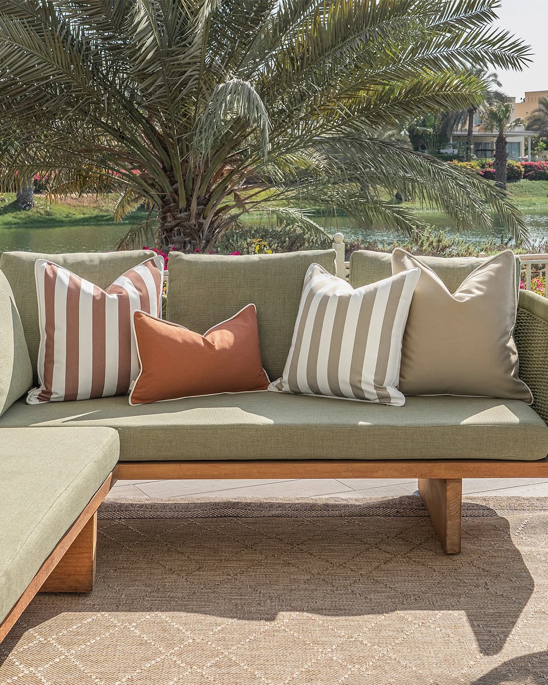Manha Bundle cushion in rust and beige, shown in a lifestyle front view as image 4
