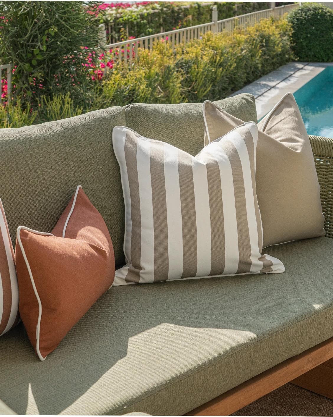 Manha Bundle cushion in rust and beige, shown in a lifestyle left view as image 5