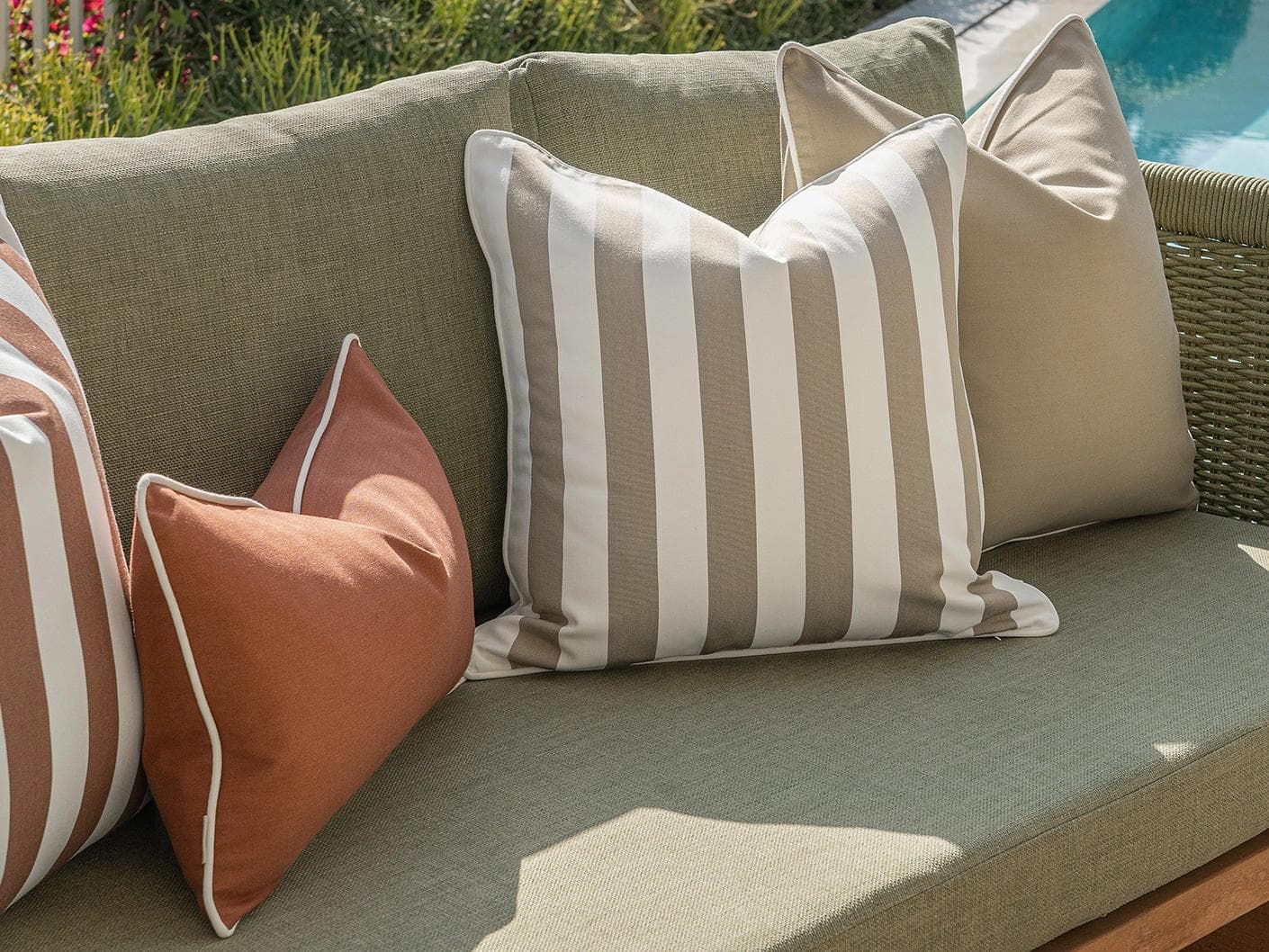 Manha Bundle cushion in rust and beige, shown in a lifestyle left view as image 5